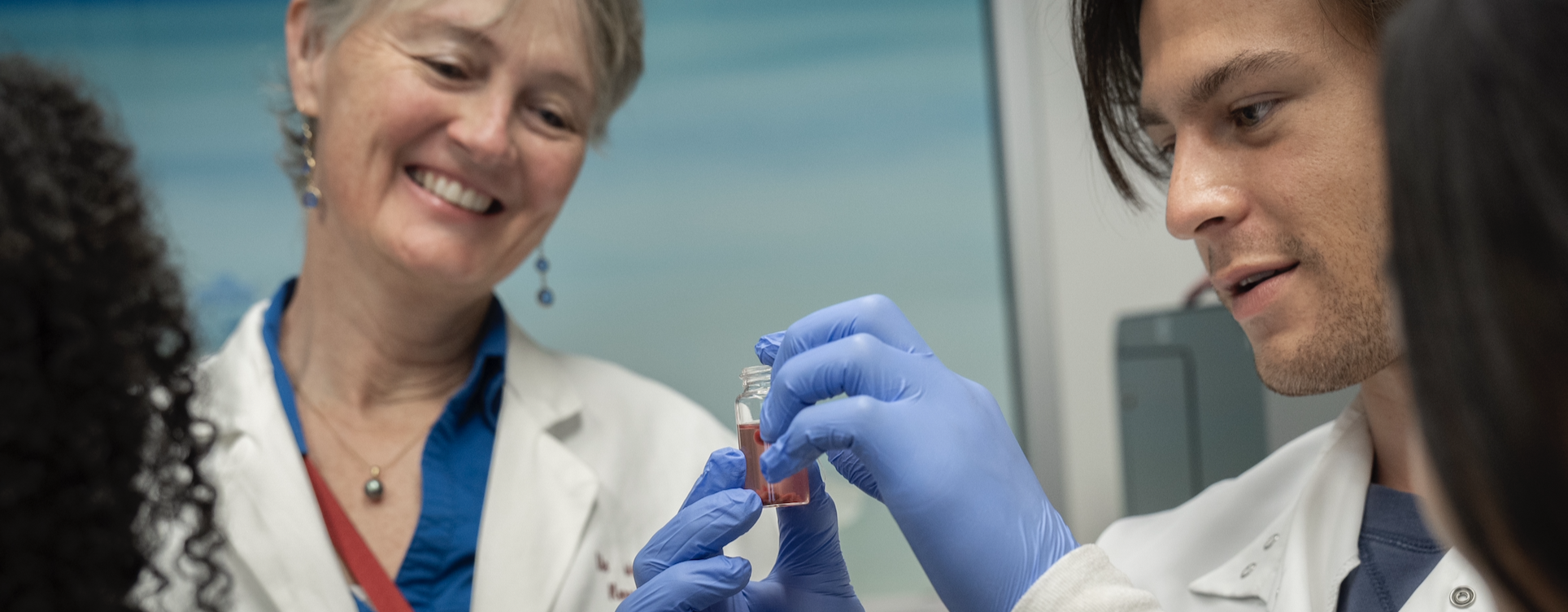 Dr. Offringa and Dr. Velarde look at a sample from a mouse.